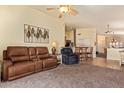 Open-concept living area featuring comfortable seating and easy access to the kitchen and dining areas at 16274 N 138Th Ln, Surprise, AZ 85374