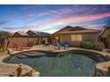 Inviting backyard oasis with a private pool, patio, and lush landscaping at 17244 W Mohave St, Goodyear, AZ 85338