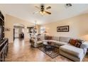 Spacious living room featuring tile floors and an open layout to the kitchen at 17244 W Mohave St, Goodyear, AZ 85338