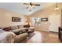 Comfortable living room with a vaulted ceiling, tile flooring, and natural light at 17244 W Mohave St, Goodyear, AZ 85338