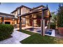 Relaxing backyard oasis with a spa, pergola, outdoor kitchen and lush landscaping at 19922 N 101St Pl, Scottsdale, AZ 85255