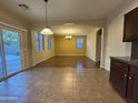 Bright dining room with an open layout, tile floors, sliding glass doors, and large windows for ample natural light at 20426 N Alma Dr, Maricopa, AZ 85138