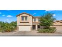 Charming two-story home featuring a two-car garage, well-manicured landscaping, and inviting curb appeal at 20426 N Alma Dr, Maricopa, AZ 85138