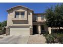 Beautiful two-story home with a two-car garage, desert-style landscaping, and a charming front porch at 20426 N Alma Dr, Maricopa, AZ 85138