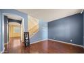 Inviting living room showcasing hardwood floors, neutral walls, and an staircase at 20426 N Alma Dr, Maricopa, AZ 85138