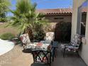 Comfortable outdoor patio seating area with colorful floral cushions and brick pavers at 20426 N Alma Dr, Maricopa, AZ 85138