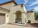 View of the exterior of the home including the front entryway with decorative arches and columns at 20472 W Daniel Pl, Buckeye, AZ 85396