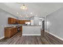 Spacious kitchen with wood cabinets, stainless steel appliances, and a breakfast bar overlooking the living area at 21616 E Calle De Flores --, Queen Creek, AZ 85142