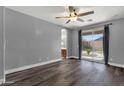 Serene main bedroom with wood-look floors, ceiling fan, and access to the backyard through sliding glass doors at 21616 E Calle De Flores --, Queen Creek, AZ 85142