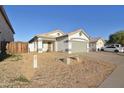 Inviting single-story home with desert landscaping, a two-car garage, and a neutral color scheme at 2667 S 156Th Ave, Goodyear, AZ 85338