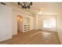 Bright and airy living room with new laminate floors, ceiling fan, and custom built-in shelving at 2667 S 156Th Ave, Goodyear, AZ 85338