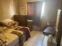 Modest bedroom featuring neutral tones, a large window, and traditional furnishings at 277 W 16Th Ave, Apache Junction, AZ 85120