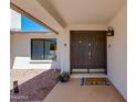 Inviting entryway featuring a double door, modern sconces, and view to the front yard at 3020 E Mission Ln, Phoenix, AZ 85028