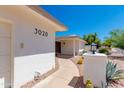 View of the front of the home showing desert landscaping and a walkway to the front door at 3020 E Mission Ln, Phoenix, AZ 85028