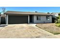 Well-lit single-story home with a neat front yard and a convenient two-car garage at 344 E Jacaranda St, Mesa, AZ 85201