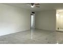 Bright and airy living room with a marble-patterned floor, freshly painted walls, and lots of natural light at 344 E Jacaranda St, Mesa, AZ 85201