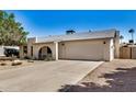 Exterior view of home featuring desert landscaping, two car garage, and a front porch at 4121 W Paradise Dr, Phoenix, AZ 85029