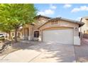 Well-maintained single-story home featuring a two-car garage and desert landscaping at 418 E Clairidge Dr, San Tan Valley, AZ 85143