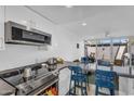 Bright, open kitchen with stainless steel appliances, modern cabinetry, and a breakfast bar with seating at 4411 N 40Th St # 59, Phoenix, AZ 85018