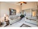 Comfortable living room featuring plush seating, bright neutral paint, and an art-filled space at 4531 W Continental Dr, Glendale, AZ 85308