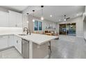 Open-concept kitchen with quartz countertops, stainless steel appliances, and a view of the living area at 506 E Balao Dr, Phoenix, AZ 85085