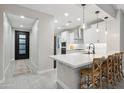 Modern kitchen features a center island with bar seating, stainless appliances, and a walk-in pantry at 506 E Balao Dr, Phoenix, AZ 85085