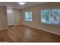 Inviting living room featuring two bright windows with ample natural light and hardwood floors at 549 E Mckellips Rd # 18, Mesa, AZ 85203