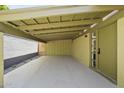 Open carport featuring a concrete floor and an adjacent entrance to the home at 5815 N 10Th Pl, Phoenix, AZ 85014