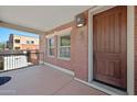 Cozy covered porch with exterior brick details and a wooden front door at 625 S Roosevelt St, Tempe, AZ 85281