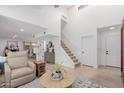 Bright living room with high ceilings, white walls, hardwood floors, and a staircase at 6350 N 78Th St # 280, Scottsdale, AZ 85250