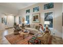 Bright living room with neutral walls, fireplace, and large windows with shutters at 6767 E Nightingale Star Cir, Scottsdale, AZ 85266