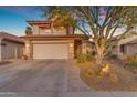 Charming two-story home with a tile roof, attached garage, and a desert-landscaped front yard at 6841 S Roosevelt St, Tempe, AZ 85283