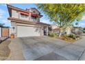 Charming two-story home with a tile roof, attached garage, and a desert-landscaped front yard and driveway at 6841 S Roosevelt St, Tempe, AZ 85283