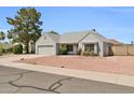 Charming single-story home featuring a well-maintained gray exterior, desert landscaping, and an attached two-car garage at 7114 W Yucca St, Peoria, AZ 85345