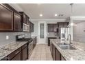 Gourmet kitchen featuring granite counters, stainless steel appliances, and a walk-in pantry at 716 W Blue Ridge Dr, San Tan Valley, AZ 85140