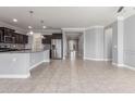 Open concept living space adjacent to kitchen features tile floors and neutral colored walls at 716 W Blue Ridge Dr, San Tan Valley, AZ 85140