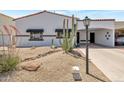 Inviting front yard with desert landscaping, river rock drainage, and mature Saguaro cactus at 7643 E Rancho Vista Dr, Scottsdale, AZ 85251