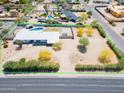 Aerial view showcasing property with pool, landscaping, fencing, and proximity to the main thoroughfare at 7667 E Cactus Rd, Scottsdale, AZ 85260
