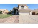 Charming two-story home with a well-kept lawn and a wide driveway leading to a two-car garage at 8017 W Eugie Ave, Peoria, AZ 85381