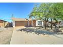 Traditional single-story brick home with two-car garage and desert landscaping at 8220 E Montecito Ave, Scottsdale, AZ 85251