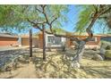 Charming single-story brick home with desert landscaping and a two-car garage at 8220 E Montecito Ave, Scottsdale, AZ 85251