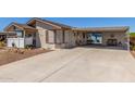 Inviting single-story home with extended driveway and covered carport area for outdoor seating at 8840 E Sunland Ave # 137, Mesa, AZ 85208