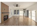 Open living room featuring hardwood floors, modern fireplace, and plenty of natural light at 942 S Ash Ave # 104, Tempe, AZ 85281