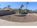 Inviting single-story home showcasing desert rock landscaping, mature palm trees, and a convenient two car garage at 9612 N 52Nd Dr, Glendale, AZ 85302