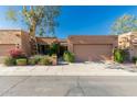 Charming single-story home with a two-car garage, mature trees and flowering bushes enhancing curb appeal at 1010 E Lois Ln, Phoenix, AZ 85020