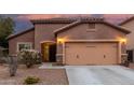Charming stucco home with a two-car garage and desert landscaping at dusk at 10811 W Avenida Del Rey --, Peoria, AZ 85383