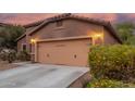 Two-car garage of single Gathering home with desert landscaping in the front yard at 10811 W Avenida Del Rey --, Peoria, AZ 85383