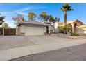 Attractive tan home with a two car garage, desert landscaping, and blue skies overhead at 1120 E Harbor View Dr, Gilbert, AZ 85234