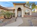 Inviting covered entrance with desert rock landscaping and a decorative walkway path at 1120 E Harbor View Dr, Gilbert, AZ 85234