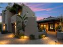 Southwestern home featuring a brick driveway, desert landscaping and a covered entryway with accent lighting at 11398 E Desert Vista Rd, Scottsdale, AZ 85255